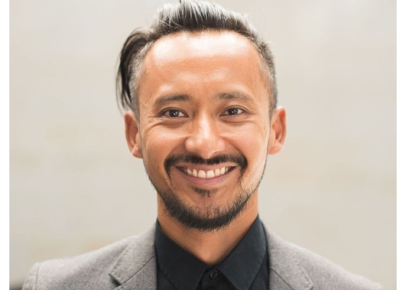 Professional man in grey suit smiles in portrait shot